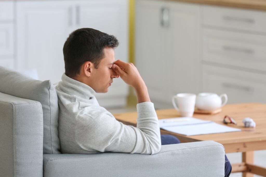 Stressed young man at home