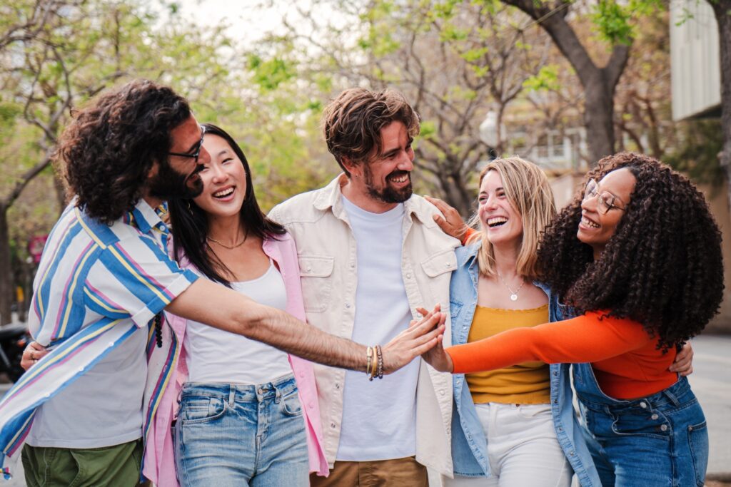 Group of happy friends having fun and laughing together outside, building connections