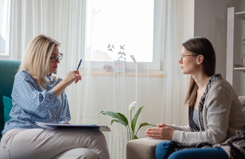 Woman psychotherapist during a therapy session with female client