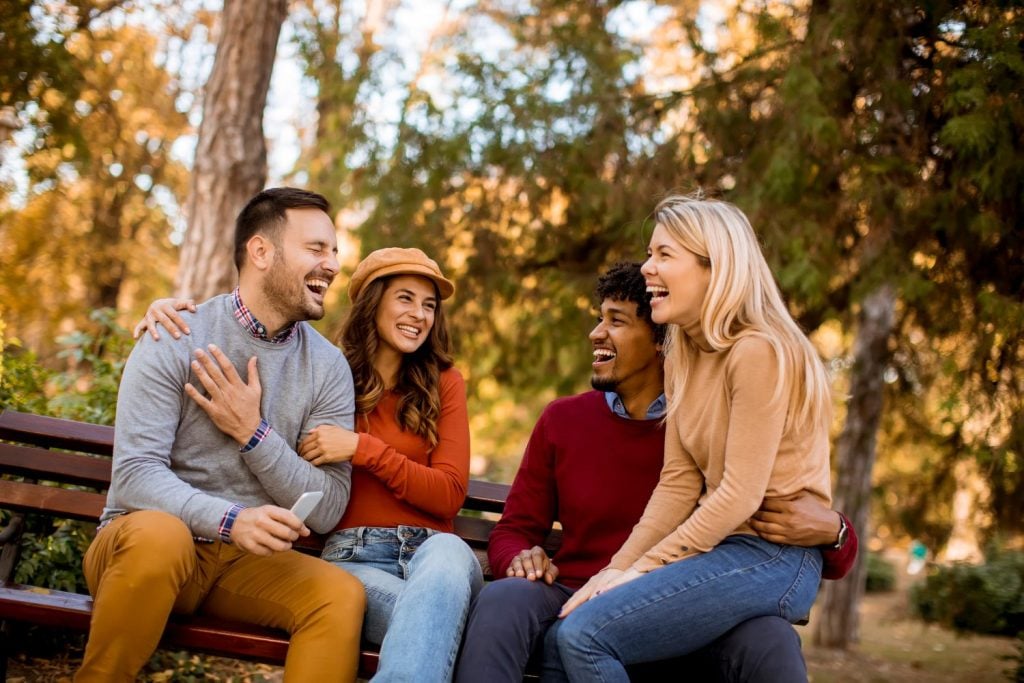 Group of young multiethnic friends having fun at park, concept of friendship, healthy relationships