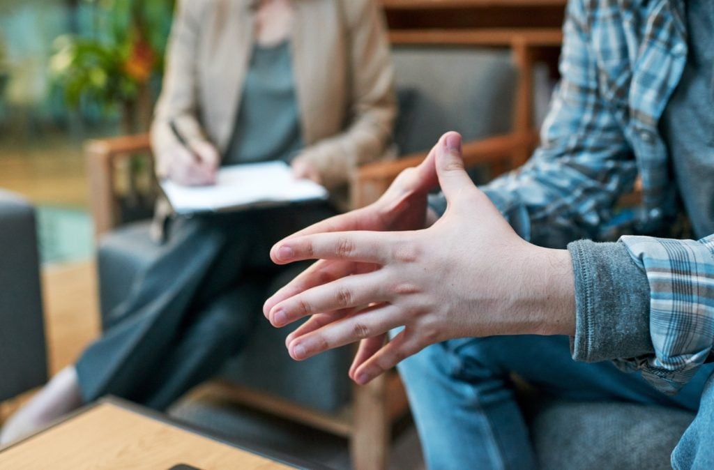 Cropped shot of a man having a therapeutic session with a psychologist