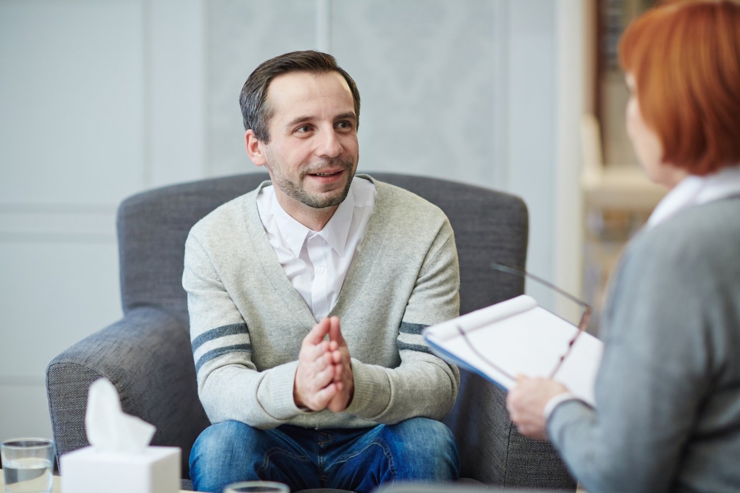 Happy man looking at his psychologist during conversation