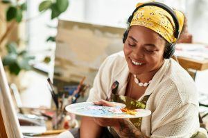 woman enjoys painting in a vibrant craft workshop during a sunny afternoon