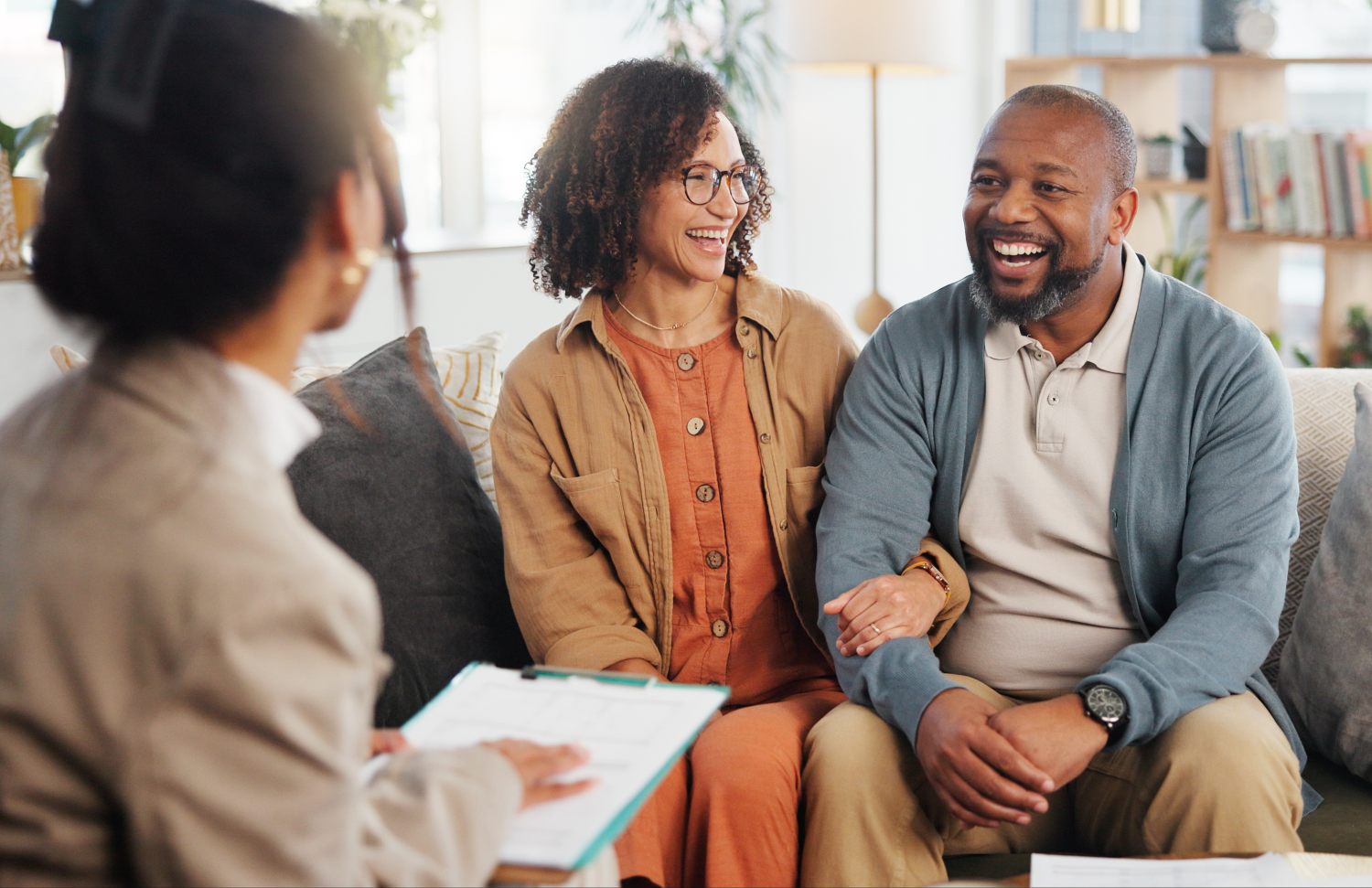 couple happily speaking with therapist during a family therapy session
