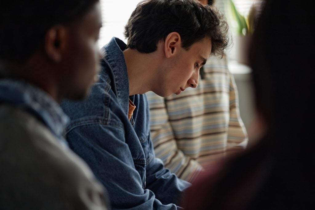 focused shot of a man during a group counseling