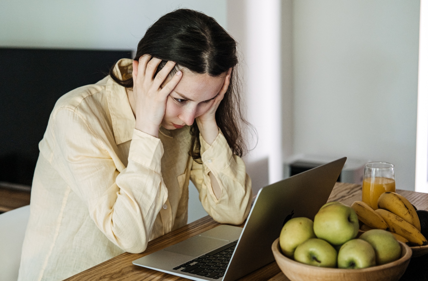 frustrated woman looking at her laptop, concept of struggling with work and daily life