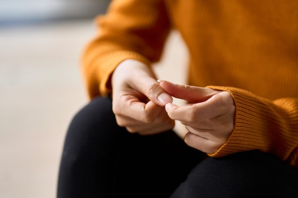 hands of a woman, playing with fingernails, concept of anxiety