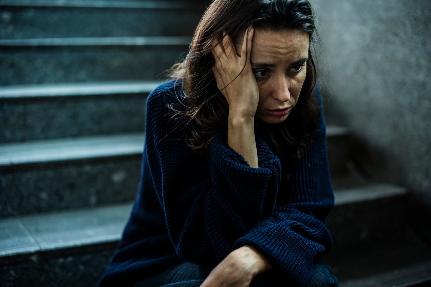 Woman in Distress Sits on Concrete Steps